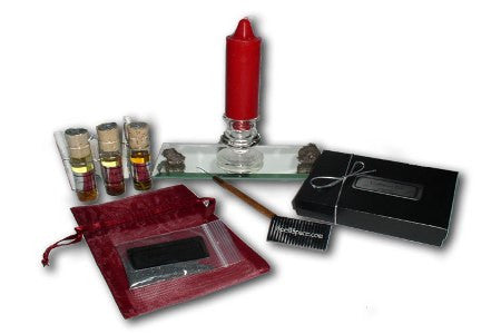 Attract Love Spell kit with red candle, vials, lodestones, mirror, and black box packaging