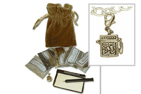 Gold Luck Charm talisman pendant with magical herbs, velvet bag, pen, and paper for good luck rituals